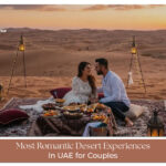 Couple enjoying desert sunset UAE dunes